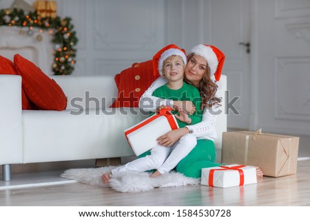 Stock foto: Mom And Son In New Years Outfits And Good Mood Posing In Front Of The Camera On New Years Day