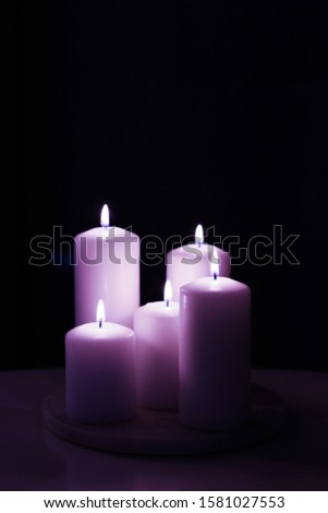 Foto d'archivio: Aromatic Purple Floral Candles Set At Night Christmas New Year