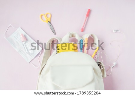 Stok fotoğraf: School Supplies Protective Mask And Antiseptic On A Pink Background