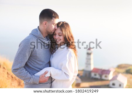 Stockfoto: Romantic Couple Dressed In Cozy Sweaters Together Near The Light