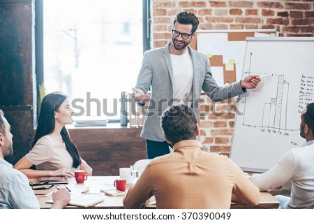 Foto stock: Businessman Standing Near Whiteboard And Pointing On The Chart Of Finance Analytics