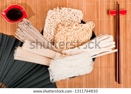 ストックフォト: Assortment Bundles Of Uncooked Asian Noodles Close Up On White Wooden Board Background Top View