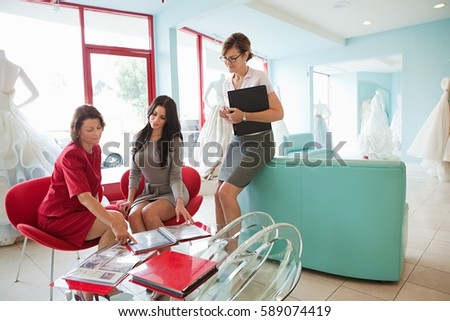 Stock fotó: Mother And Daughter Talking To Wedding Dress Designer