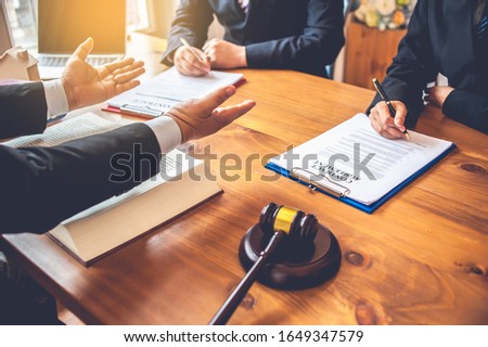 Foto stock: Business People And Lawyers Discussing Contract Papers Sitting A