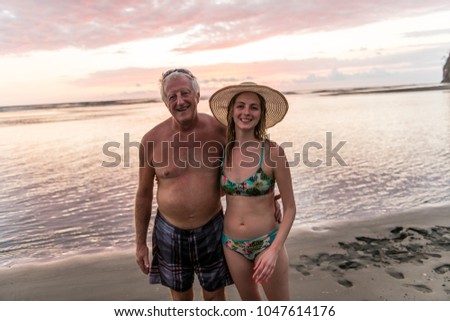 Foto d'archivio: A 60s Man At The Beach Having Good Time With Daughter On Vacancy