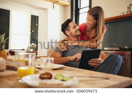 Stok fotoğraf: Happy Couple Enjoy Each Other In The Modern Kitchen While Man Ho
