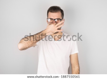 Foto stock: Young Man With Disgust On His Face Pinches Nose Something Stinks Very Bad Smell In Swimming Pool B