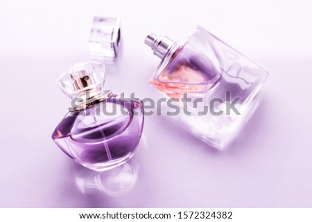 Stok fotoğraf: Purple Perfume Bottle On Glossy Background Sweet Floral Scent