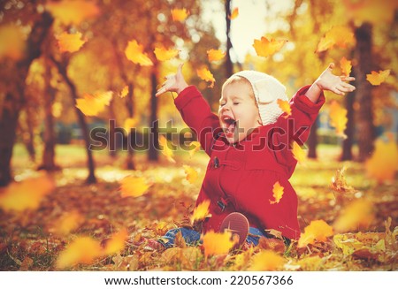 Stock foto: Little Girl Playing With Autumn Leaves