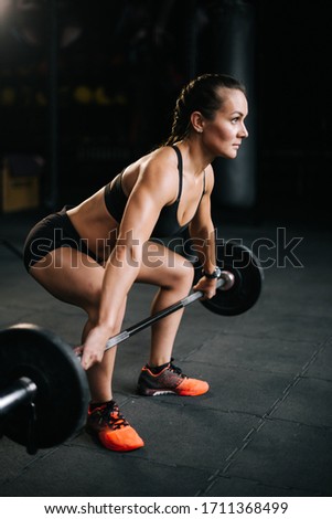 Stock foto: Full Length Portrait Of A Young Sportswoman Holding Heavy Dumbbell