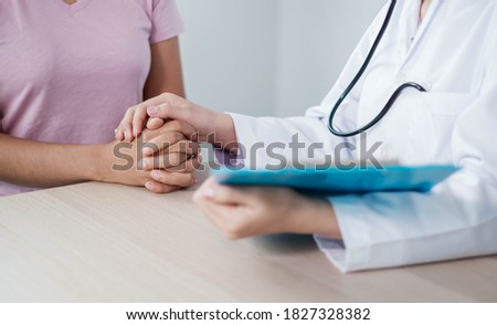 Stock fotó: Patient Being Reassured Desperate Holding Hand By Doctor Encoura