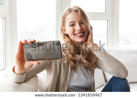 [[stock_photo]]: Image Of Charming Blond Woman Smiling And Taking Selfie Photo I