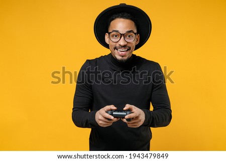 Foto d'archivio: Portrait Of African American Gamer Boy Wearing Hat And Scarf Pla