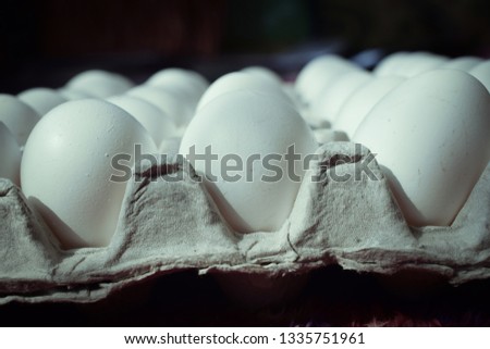 Сток-фото: Closeup Of Black Cardboard Box With White And Red Raw Eggs On Black Background With Copy Space East