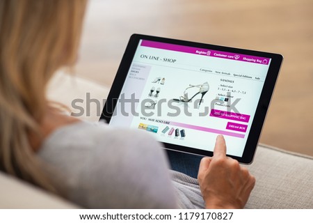 Stock photo: Doing Online Shopping On Digital Tablet At Home Browsing Find N