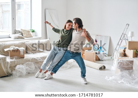 Сток-фото: Cheerful Ethnic Couple On Floor Of New Apartment