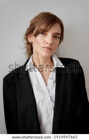 Imagine de stoc: Portrait Of Passionate Young Brunette In Black Clothes Isolated