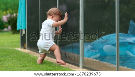 Stockfoto: Barrier For The Safety Of Children With A Pool In The Background