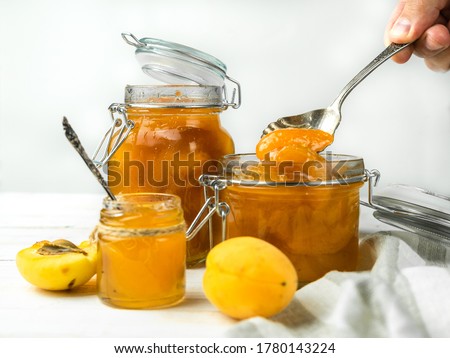 Foto stock: Apricot Jam In A Jar And Fresh Fruits With Leaves On White Wooden Table Breakfast