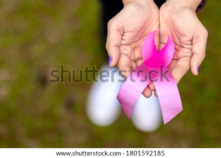 [[stock_photo]]: Human Hand Showing Green Ribbon To Support Breast Cancer Cause