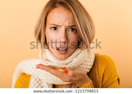 Stock fotó: Sad Displeased Woman Wearing Scarf Holding Pills Isolated Over Yellow Wall Background