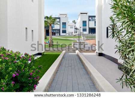 Stock foto: Between Two White Residential Houses View To Green Lawn Of Resid