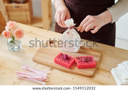 Stock fotó: Hands Of Woman Decorating Paper Packet With Flowers While Packing Handmade Soap