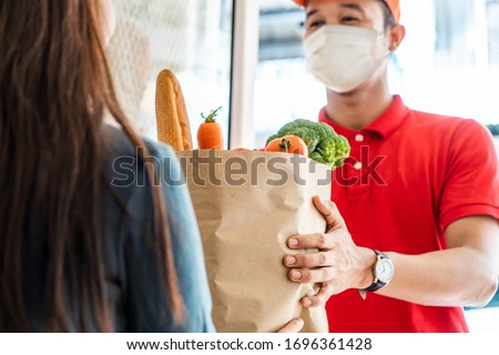 Stock photo: Courier Delivers Online Purchases To The Door During The Coronavirus Epidemic