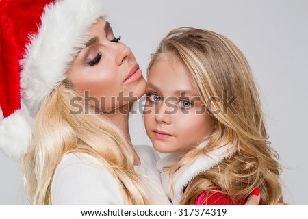Stock fotó: Beautiful Sexy Blonde Female Model Mother And Daughter Dressed As Santa Claus In A Red Cap With At T