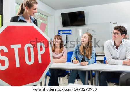 Foto stock: Driving Instructor Holding Theoretical Part Of Driving Lessons