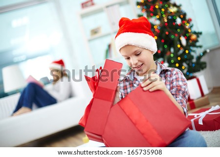 Girl Opening A Christmas Present Box With A Wonderful Surprise Сток-фото © Pressmaster