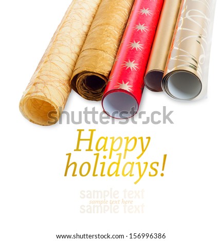 Foto stock: Rolls Of Multicolored Wrapping Paper For Gifts On Gold Backgroun