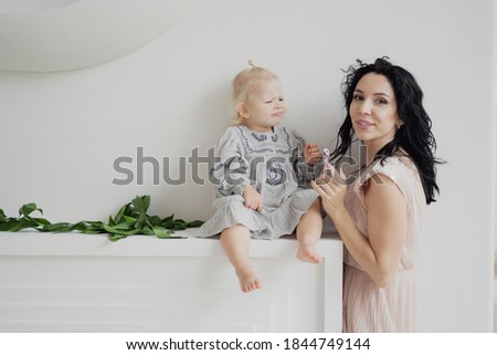 Stock foto: Smiling Woman Playing With Her Ponytail Sitting On Wooden Box