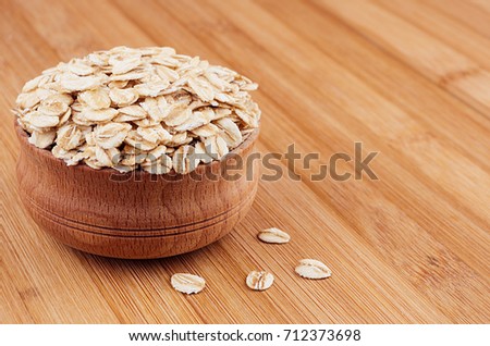 Сток-фото: Oat Flake In Wooden Bowl On Brown Bamboo Board Closeup Rustic Style Healthy Dietary Groats Backg