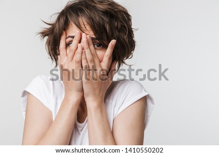 Foto stock: Photo Closeup Of Young Woman Keeping Her Hands At Face In Surpri