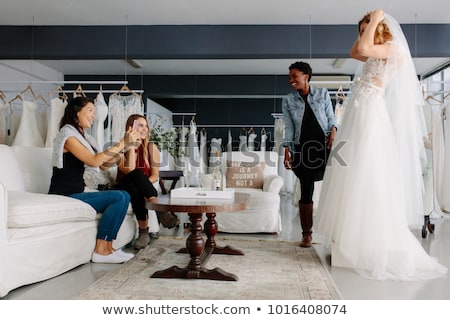 Zdjęcia stock: Bride Looking At Wedding Dresses In Bridal Boutique