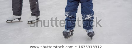 Stock fotó: Young Mother Teaching Her Little Son Ice Skating At Outdoor Skating Rink Family Enjoy Winter On Ice