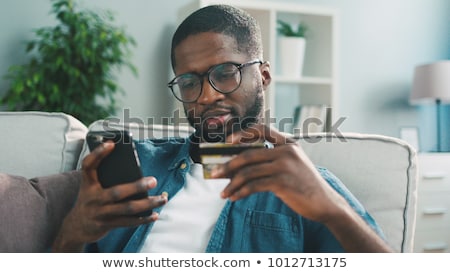 Foto stock: Man Shopping Online On Laptop Computer With Credit Card
