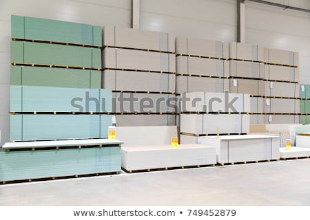 Foto stock: Gypsum Board Stacks At Indoor Warehouse