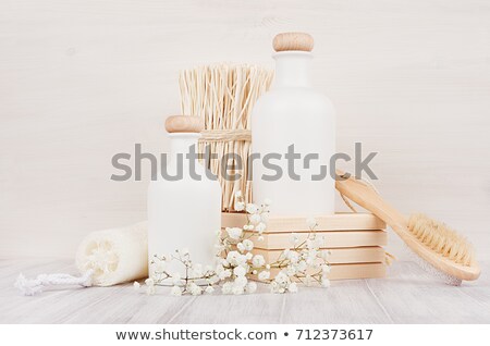 Foto stock: Blank White Cosmetics Bottles With Comb Flowers On White Wood Board Mock Up Soft Elegant Bathroom