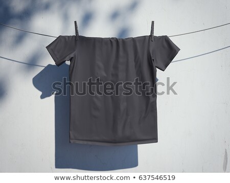 [[stock_photo]]: Blank Black T Shirt On A Rope Near Wall 3d Rendering
