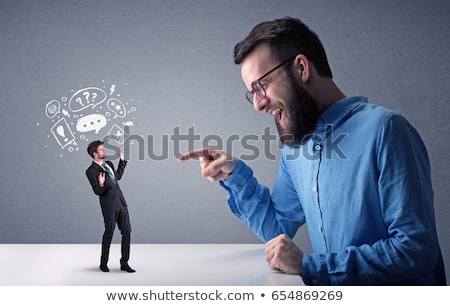 Foto d'archivio: Young Businessman Fighting With Miniature Businessman