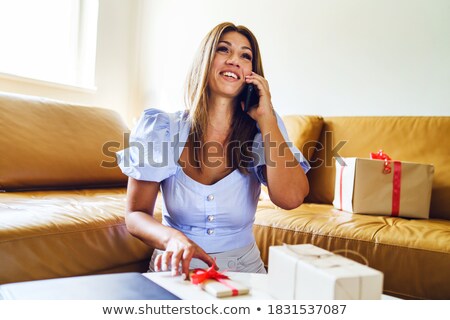 Foto stock: Beautiful Woman Opening A Gift Box While Celebrating Her Birthda