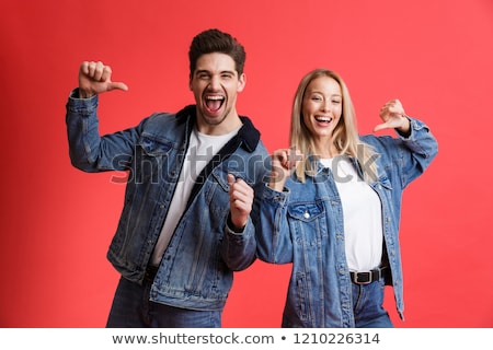 Foto d'archivio: Portrait Of A Happy Young Couple Dressed In Denim