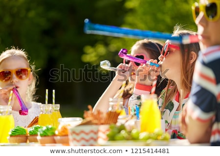 [[stock_photo]]: Happy Kids Blowing Party Horns At Summer Birthday
