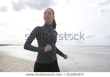 Foto d'archivio: Woman In Sports Clothes On Beach