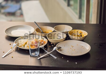 Stock fotó: The Remains Of Food In Plates Crumbs On The Table After Lunch Or Dinner