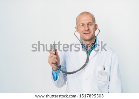 Stock photo: Smiling Bald Doctor With Stethoscope Looking At You Before Examination