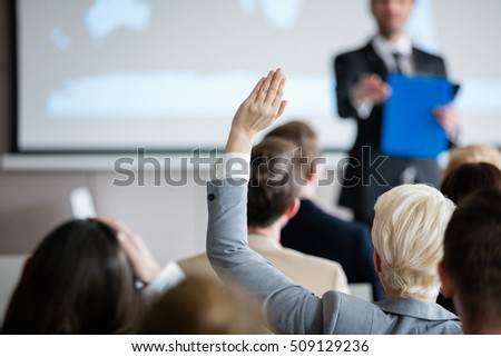 Stok fotoğraf: Front View Of Diverse Business People Raising Hands In Business Seminar In Office Building