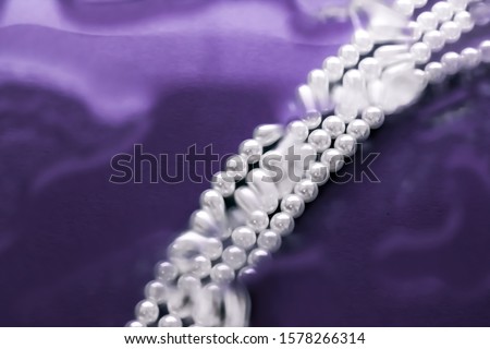 [[stock_photo]]: Coastal Jewellery Fashion Pearl Necklace Under Purple Water Bac